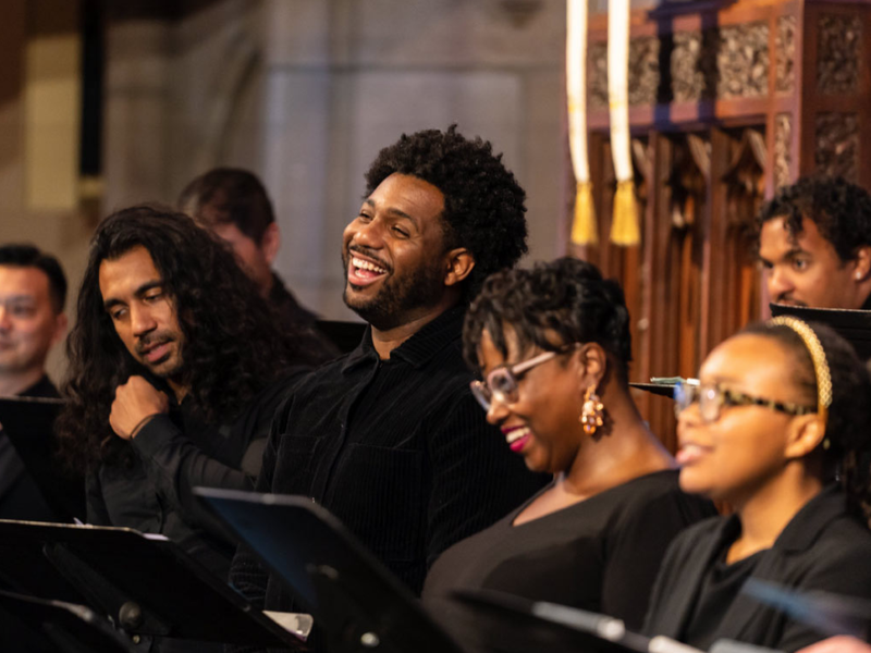 Several members of a choir singing joyously together